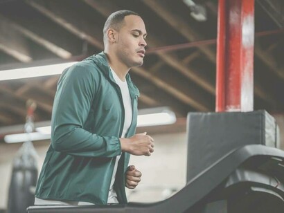 A man working out on the treadmill to keep up his fitness