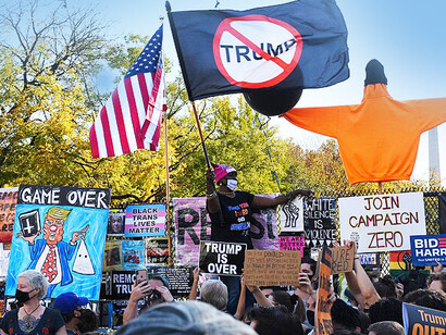 Celebrating the defeat of President Trump, 2020, people marching with 'Trump is Over' banners