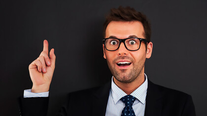 A businessman or CEO, looking happy and calm, has a breakthrough idea