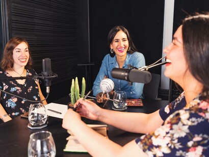 Podcasters during a moment of levity in their mental health episode