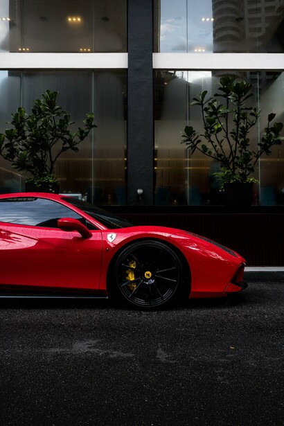 A Ferrari in front of an office building 