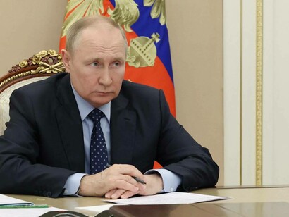 President of Russia Vladimir Putin on his desk ready to sign documents pertaining to global and local politics