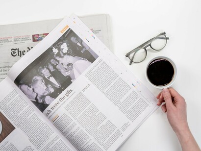 A newspaper spread beside a cup of coffee, representing the way football narratives are shaped as much by headlines as by the matches themselves
