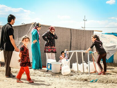 Amid hardship, a simple smile reminds us that dignity survives even in exile
