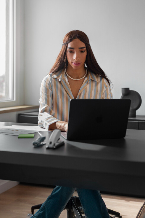 Oficinista cumpliendo sus laborales tras el escritorio. Aunque el trabajo a distancia ha crecido, sigue atando a muchos a sus hogares; los nómadas digitales, en cambio, rompen esas barreras, viviendo y trabajando en países distintos al de sus empleadores