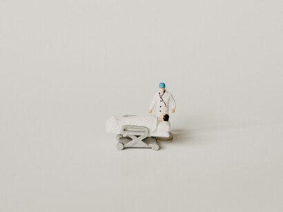 Miniatura di un lettino d'ospedale: Gli accertamenti, anziché strumento di conoscenza, sono divenuti oggetti di conoscenza “in sé”, rischiando di perdere il loro significato originale, sia per il paziente che per il medico