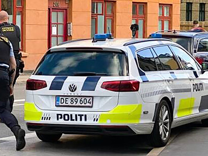 In Nørrebro, Copenhagen, two diligent police officers spring into action in response to a call for assistance, embodying the dedication to public safety and community well-being