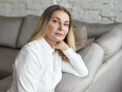 A stressed middle-aged woman captured expressively, illustrating hormonal transition and midlife women’s health