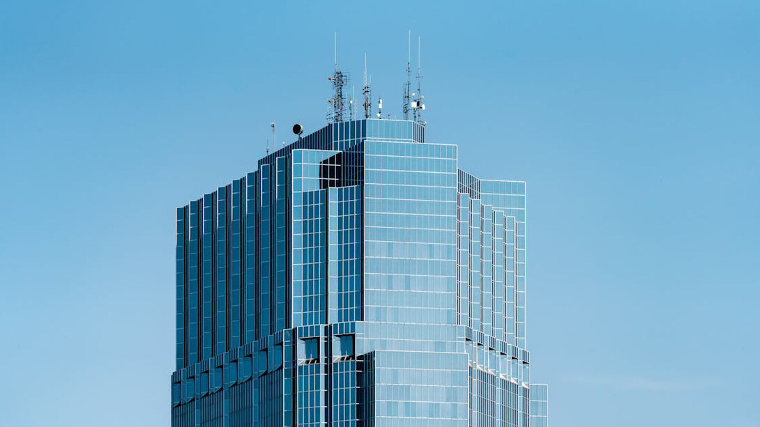 Bathed in sunlight against a brilliant blue sky, this modern architectural marvel illustrates how AI-driven design can create unique, sustainable structures for the future