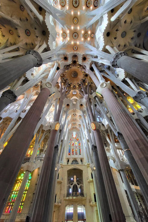La Sagrada Família in Barcelona, Spain, features a stunningly ornamented interior that exemplifies Antoni Gaudí's unique vision and dedication to craftsmanship