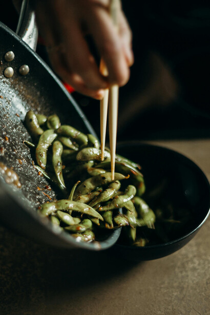 Stir-frying sweet peas and sprinkling salt on green beans — a simple example of healthy, plant-based snacks