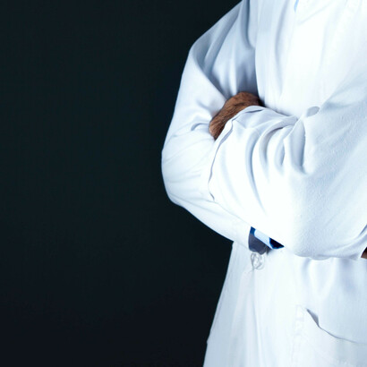 A doctor dressed in a crispy white coat, perhaps the cause of increasing your blood pressure