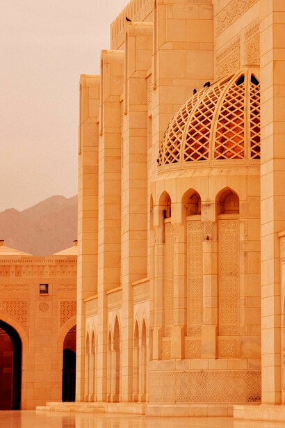 In Muscat, Oman’s Muscat Governorate, the graceful arches of the Sultan Qaboos Grand Mosque create a striking architectural impression
