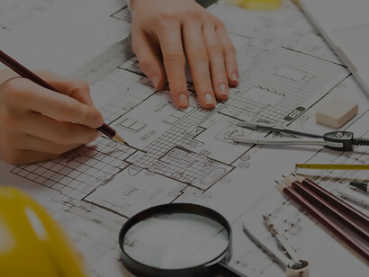 Architect sketching plans with pencil on blueprint, demonstrating meticulous attention to detail in architectural design