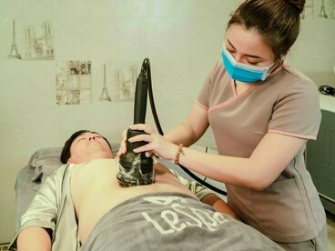 A patient undergoing a contemporary body sculpting treatment, reflecting advances in non-surgical aesthetic technology
