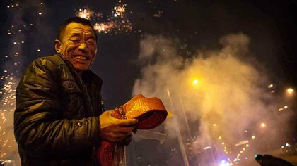 Um homem, comemorando o Ano do Macaco na China