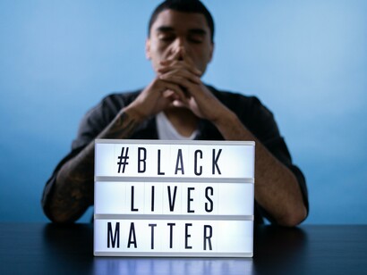 Man with a sign that reads: Black Lives Matter 