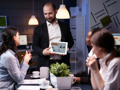 A team leader listening to the concerns of their colleagues during a discussion, reflecting the connection between listening and effective leadership