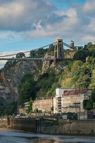 Bristol, England, United Kingdom – a bridge spanning the river against a town and mountain landscape