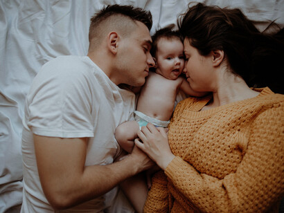 A happy family enjoys quality time together as parents play with their baby, creating cherished memories filled with love and laughter