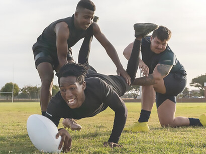 Dynamic image of men engaged in rugby action on the field in Kenya, showcasing the sport's energy and athleticism in a captivating scene