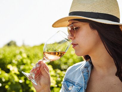 A wine enthusiast savours a glass of dessert wine, appreciating its balance of sweetness and acidity