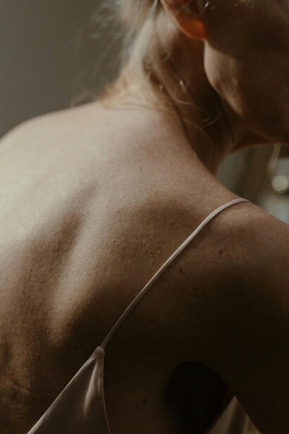 A close-up of a woman’s body reflecting natural agin