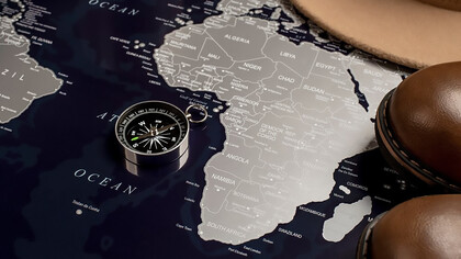 Africa continent map with a compass and shoes, symbolizing navigation and exploration possibilities across diverse landscapes