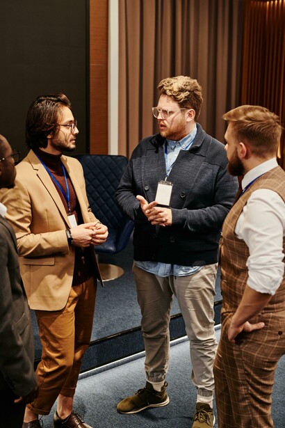 People standing and talking at a conference. We are invaded by a flow of news 