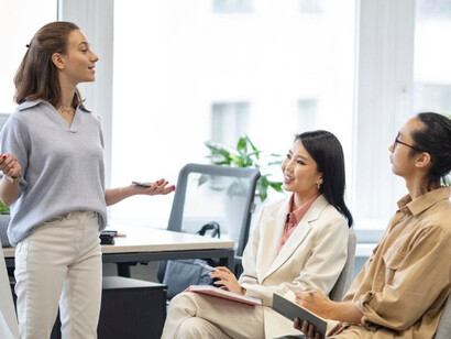 Listeners focused on a young woman leading a discussion