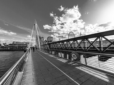 Pedestrians crossing the Golden Jubilee Bridge in London, UK