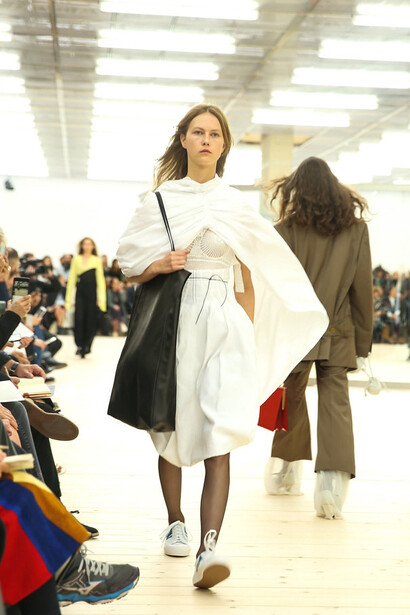 On the Celine runway, models display the latest collection, blending modern tailoring with minimalist sophistication