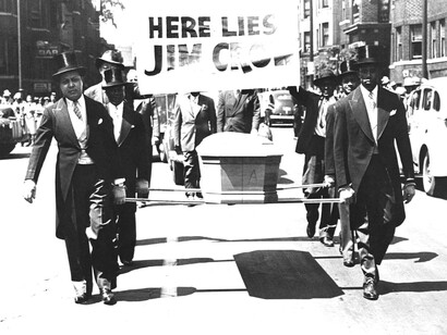 Men carry the coffin of Jim Crow in a mock funeral through the streets to protest racial discrimination in 1944