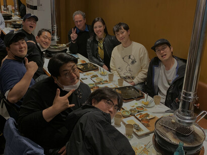 As the camera takes a break, the documentary team enjoys a meal together, bonding over shared experiences and creative collaboration