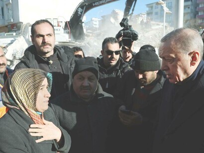Turkish President Recep Tayyip Erdogan comforts survivors of the earthquake in Kahramanmaras, Turkey