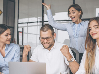 Individuals in an office setting, collaborating on a business plan with enthusiasm, showcasing teamwork, success, and inspiration