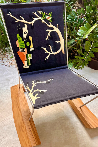An upholstered vintage chair in a Kazumi pattern depicted in Sicilian hand embroidery 