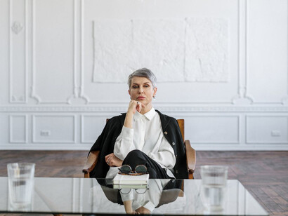 Lost in deep thought, she's contemplating how embracing change and questioning long-held beliefs can transform our understanding of the world