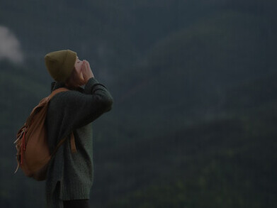 A solo female traveler revels in the serene beauty of rural landscapes, savoring the tranquility and splendor of her solo journey