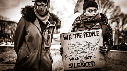 Protesters rallying against prejudice at the inauguration, standing in defiance of xenophobia and calling for inclusion and equality