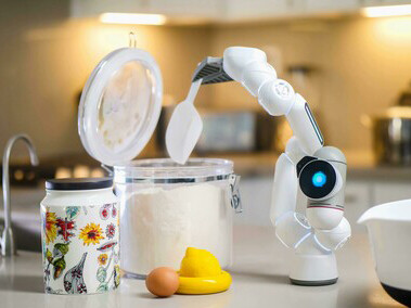 White and gray robot preparing food in a smart kitchen, symbolizing the future of AI-driven cooking