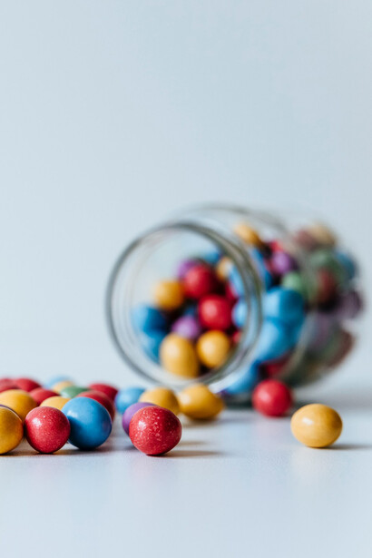 Jelly beans spilling out of jar-unhealthy nutrition is an important underlying cause of obesity