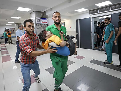 Wounded Palestinians wait for treatment at the overcrowded emergency ward of Al-Shifa hospital in Gaza City following an Israeli airstrike on October 11, 2023