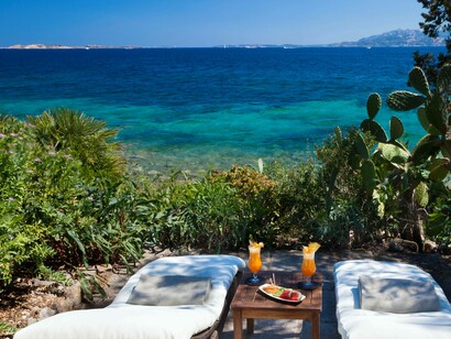 A soothing and serene location in Capo d'Orso, Sardinia where couples can grab long chairs overlooking the sea and enjoy refreshing drinks
