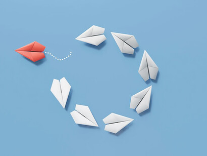 Capture the essence of individuality through an evocative image of paper planes; a standout red plane separates itself from the others, symbolizing uniqueness and independence in this compelling visual narrative
