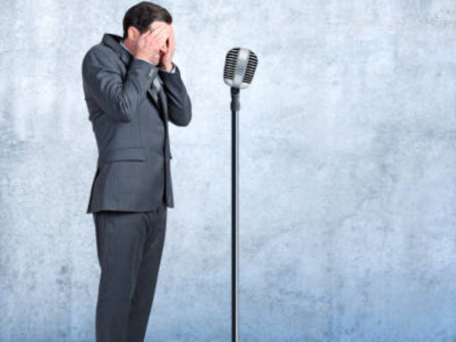 A businessman confronting the fear of public speaking showcases determination and a commitment to personal growth