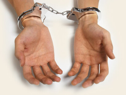 The image of handcuffed hands highlights the concept of censorship, underscoring the ongoing battle for freedom of the press and individual liberties