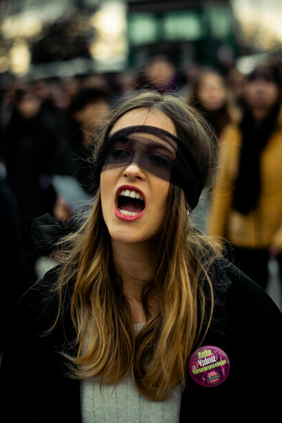 A woman wearing a transparent blindfold screams in the street
