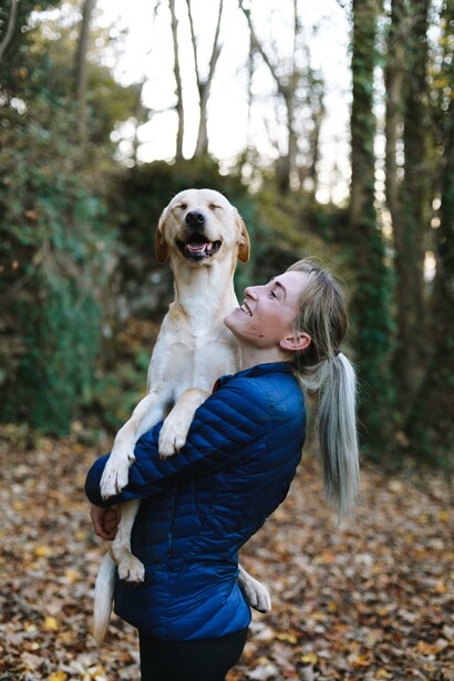 Woman and a Labrador in the woods