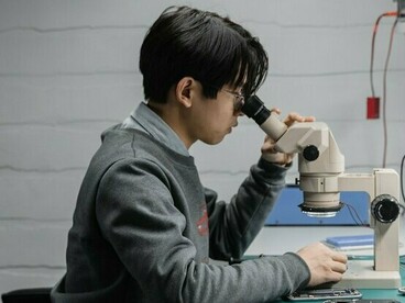 A skilled worker restoring a dismantled electronic device with precision, symbolising sustainable solutions that keep valuable technology in use for longer